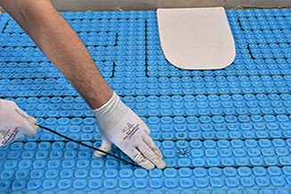 Heat cable being placed in the channels of a Prodeso membrane.